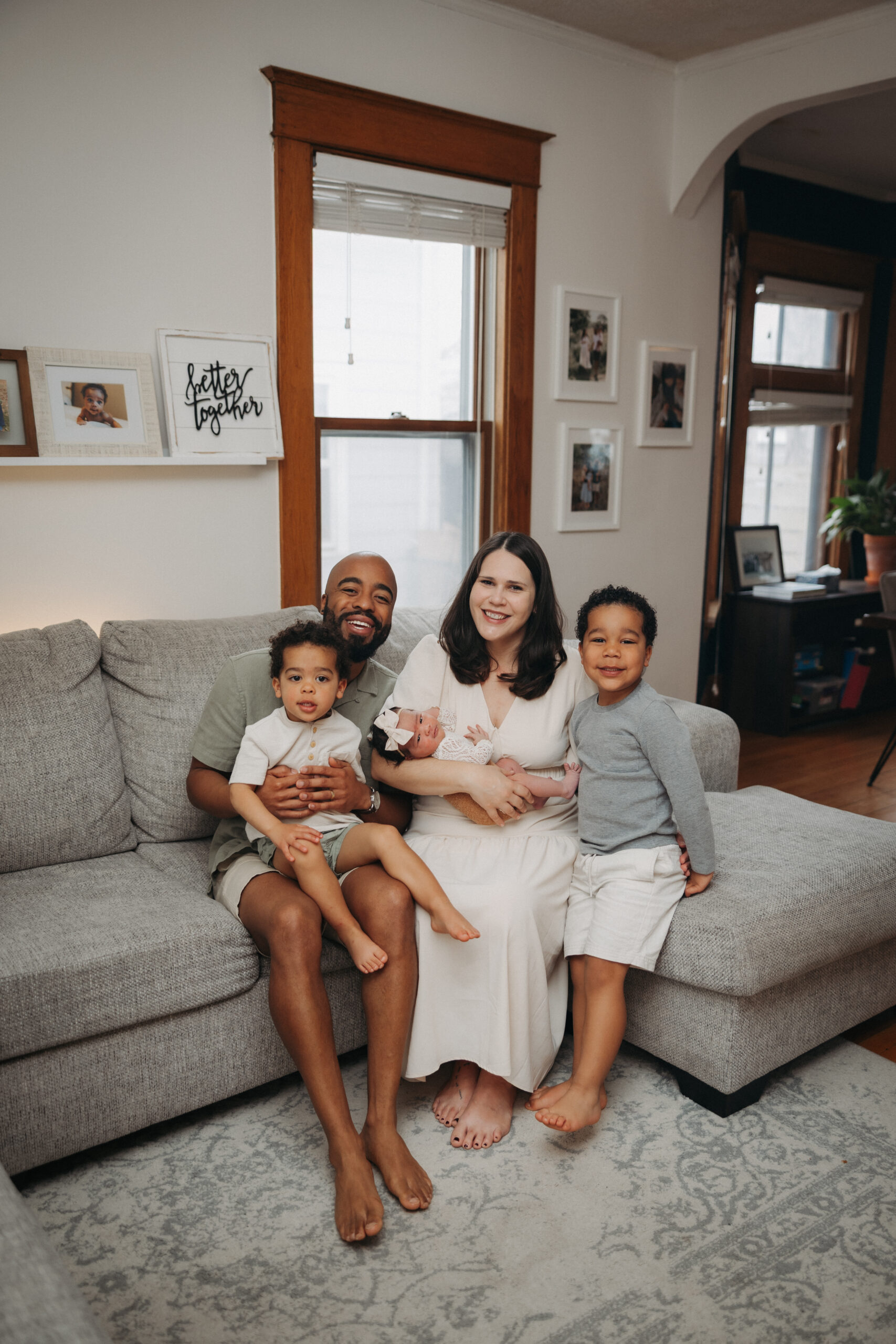 Natural light newborn portraits at home with parents and three children
