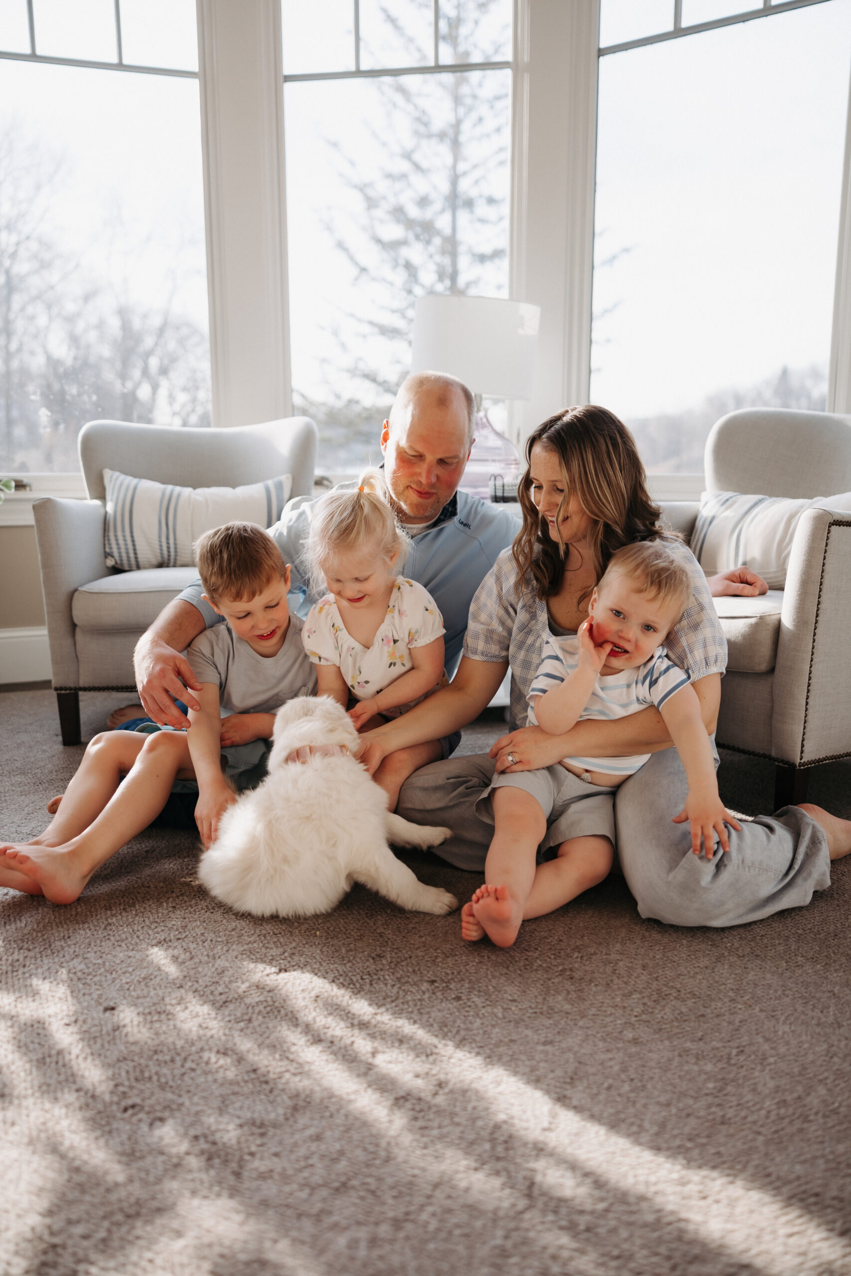 English cream golden retriever puppy with kids during an in-home puppy session in Edina MN